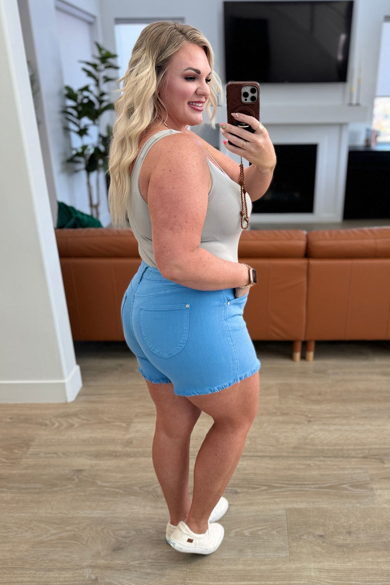 Celeste Mid Rise Shield Pocket Cutoff Shorts in Sky Blue - Maple Row Boutique